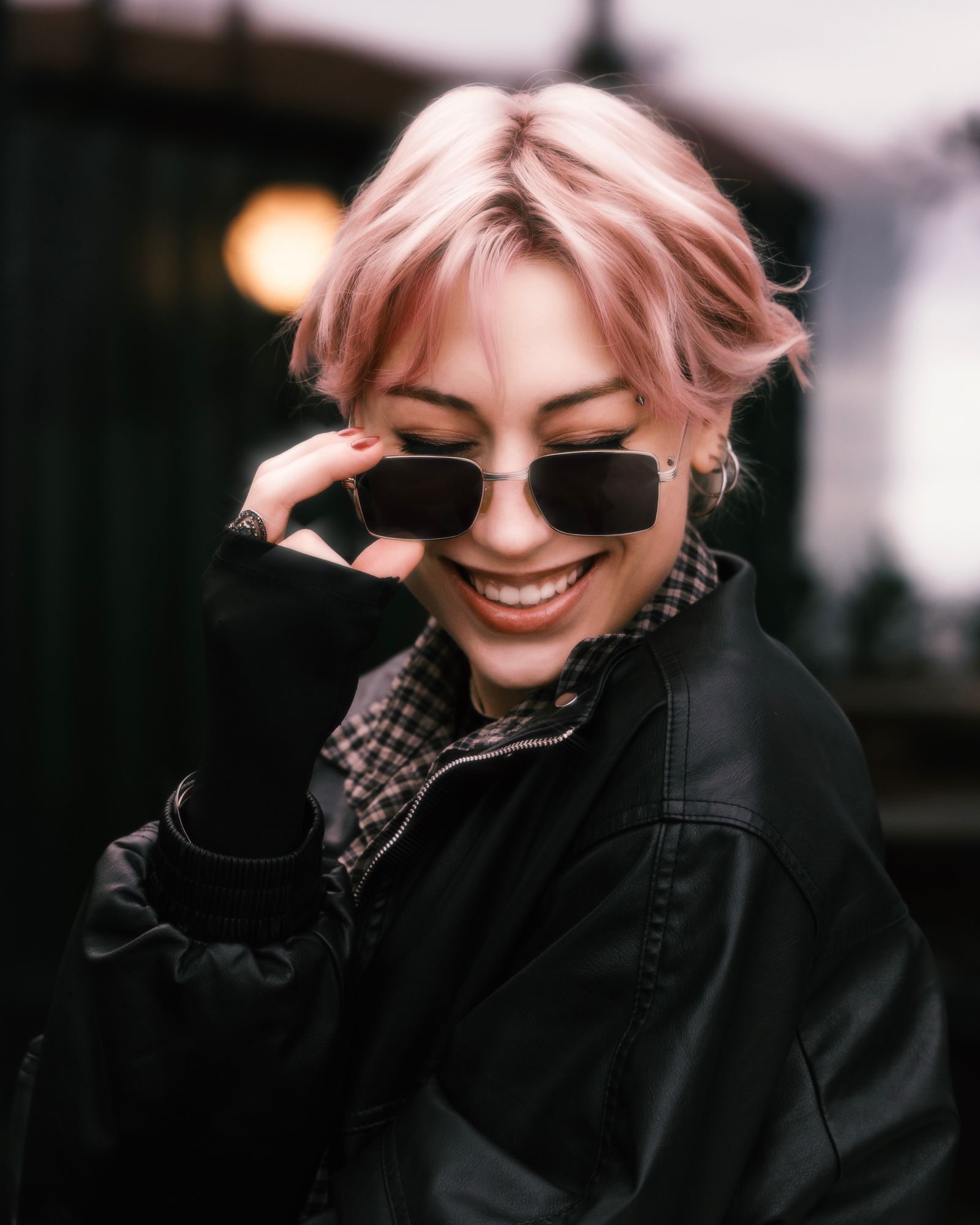Smiling woman with a pink pixie cut