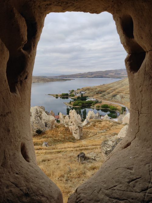 Free A picturesque view of Bayramhacı, Türkiye, seen through natural rock formations on an overcast day. Stock Photo