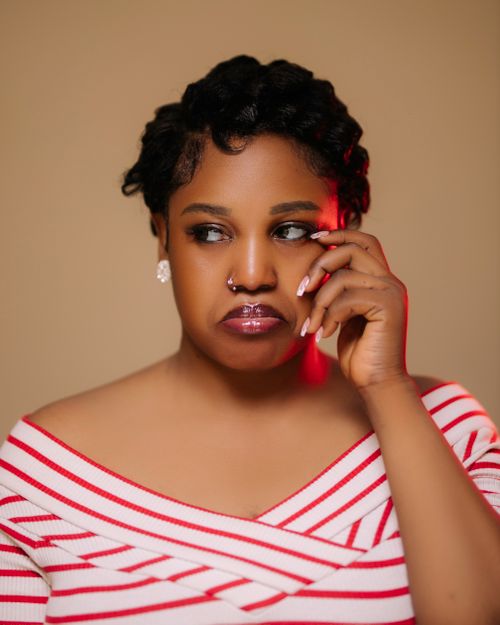 Free Thoughtful portrait of a woman with short hair and nose ring, gazing sideways. Stock Photo