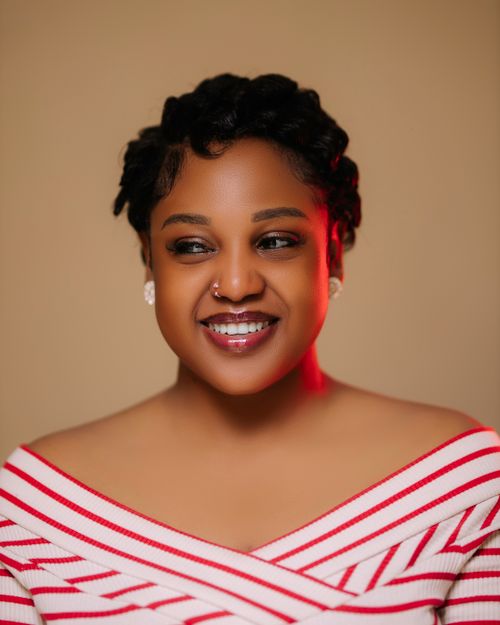 Free Close-up portrait of a smiling woman wearing a striped top with elegant makeup. Stock Photo