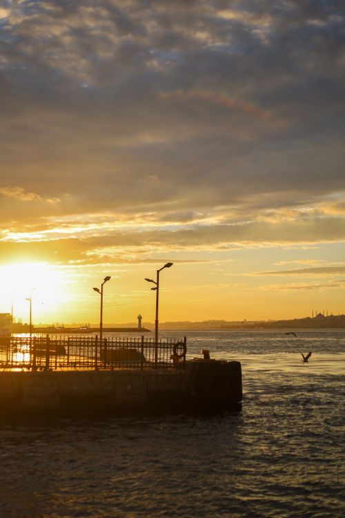 Free Stunning sunset view over the Bosphorus Strait in Istanbul, featuring vibrant skies and city silhouettes. Stock Photo