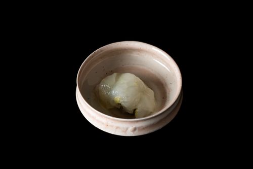 Free Elegant Japanese dish served in a rustic ceramic bowl against a black backdrop. Stock Photo