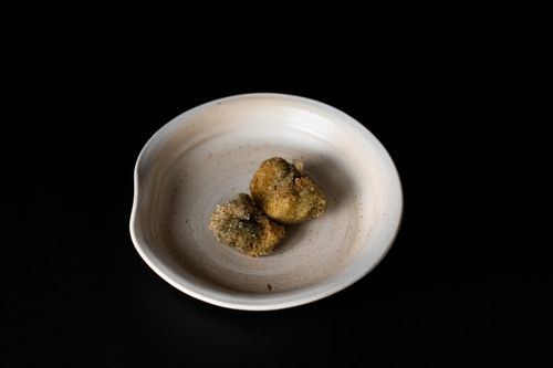 Free A close-up of Japanese fried appetizers on a rustic ceramic plate, offering an authentic taste of Tokyo cuisine. Stock Photo