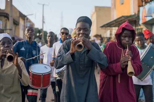 Free Vibrant street parade with young Nigerian musicians playing instruments. Stock Photo