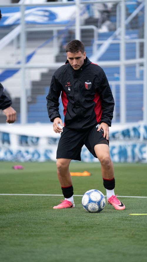 Free Soccer player practicing dribbling on the field during warm-up session. Focused and determined. Stock Photo