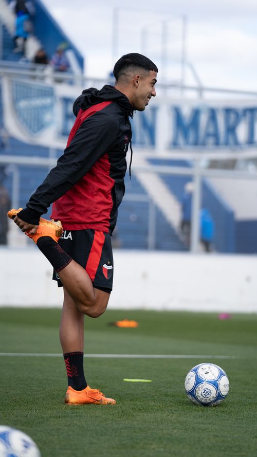 Free A soccer player stretches on the field, preparing for a match. Athleticism and fitness captured outdoors. Stock Photo