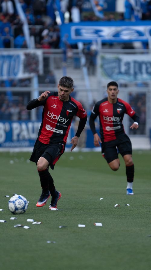 Free Dynamic action shot of soccer players in a professional match with crowd in the background. Stock Photo