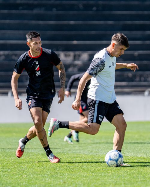 Free Intense soccer match with players competing for the ball on a grassy field. Stock Photo