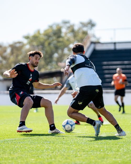 Free Action-packed soccer training with athletes on a sunny day outdoors. Stock Photo