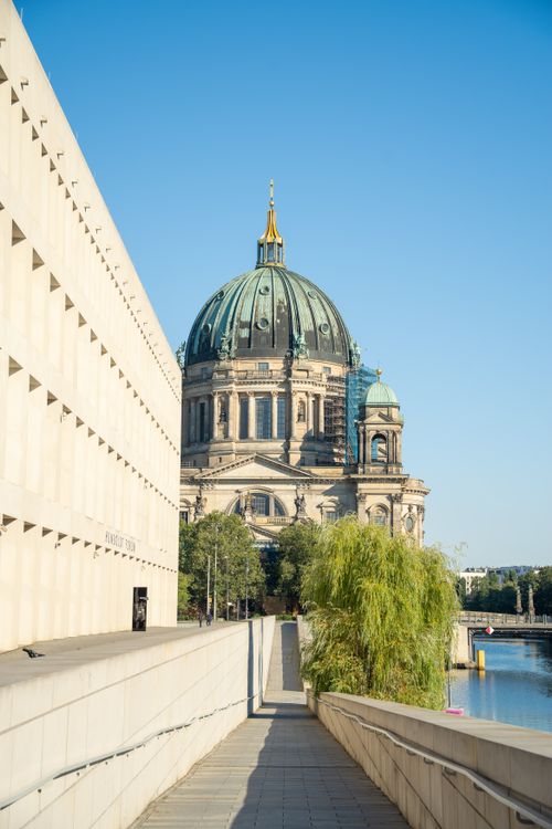 Free Capture of Berlin Cathedral paired with modern architecture and a clear blue sky near the river. Stock Photo