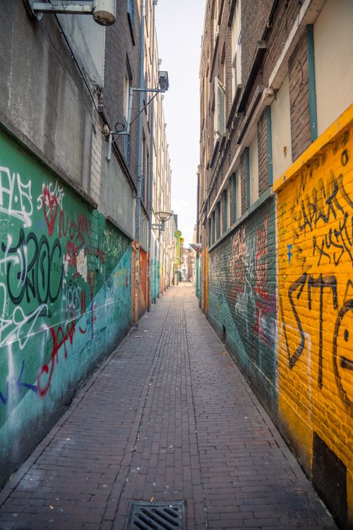 Free Vibrant alley with graffiti-covered walls in Nijmegen, Netherlands. Stock Photo