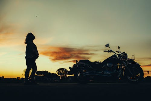 Free Silhouette of Pregnant Woman Near Motorcycle during Sunset Stock Photo