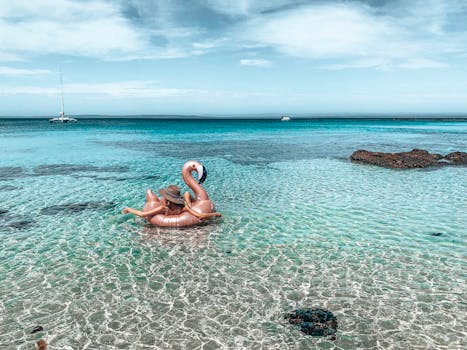 Relaxing scene of a flamingo float on a serene Australian beach.