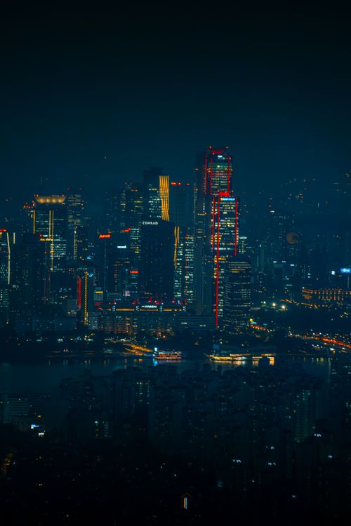 Free Vibrant night view of Seoul's illuminated skyline featuring modern skyscrapers with glowing neon lights. Stock Photo