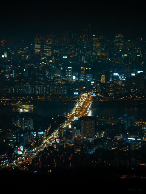 Free A breathtaking aerial view of Seoul's vibrant city lights and skyline during the night. Stock Photo