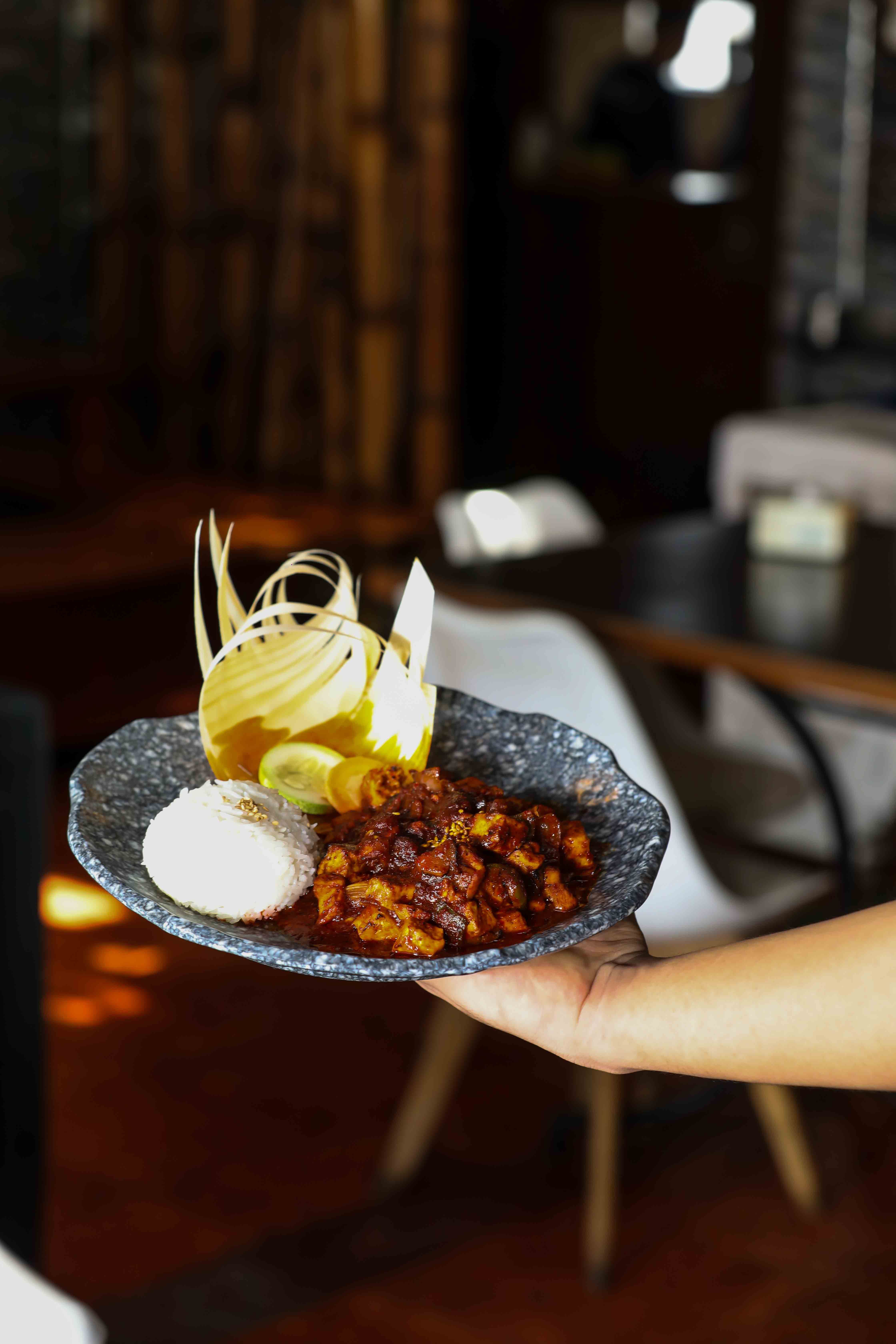A beautifully styled Indian dish served on a ceramic plate indoors.