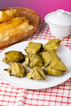 Authentic Indonesian Tape Ketan wrapped in leaves, a traditional delicacy.