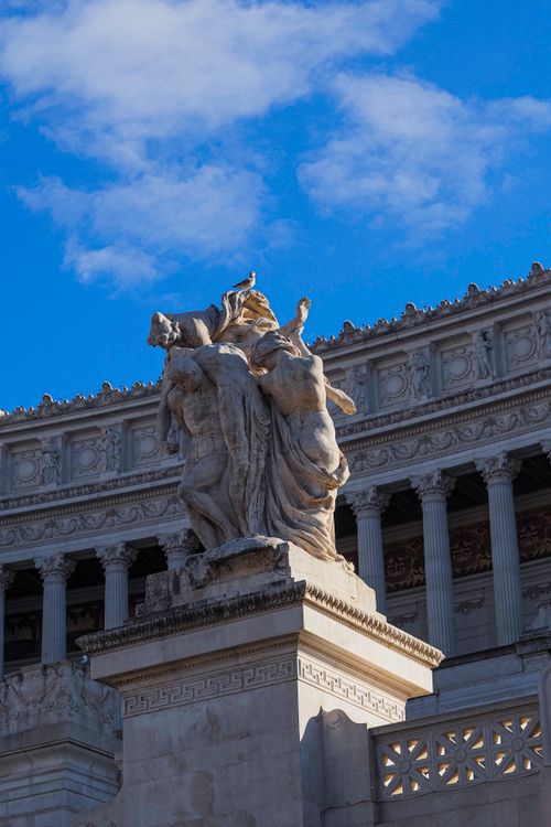 Free Elegant marble statues against a blue sky at Altare della Patria in Rome. Stock Photo