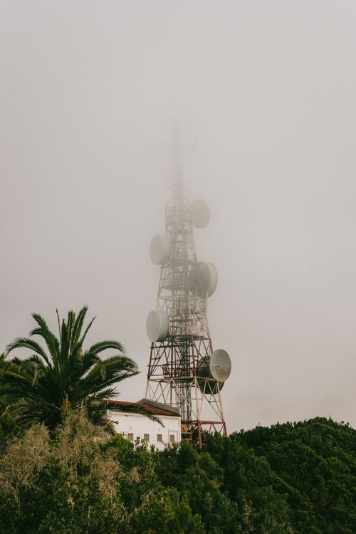 Free Misty view of a radio tower surrounded by lush greenery in Epina, Canary Islands. Stock Photo