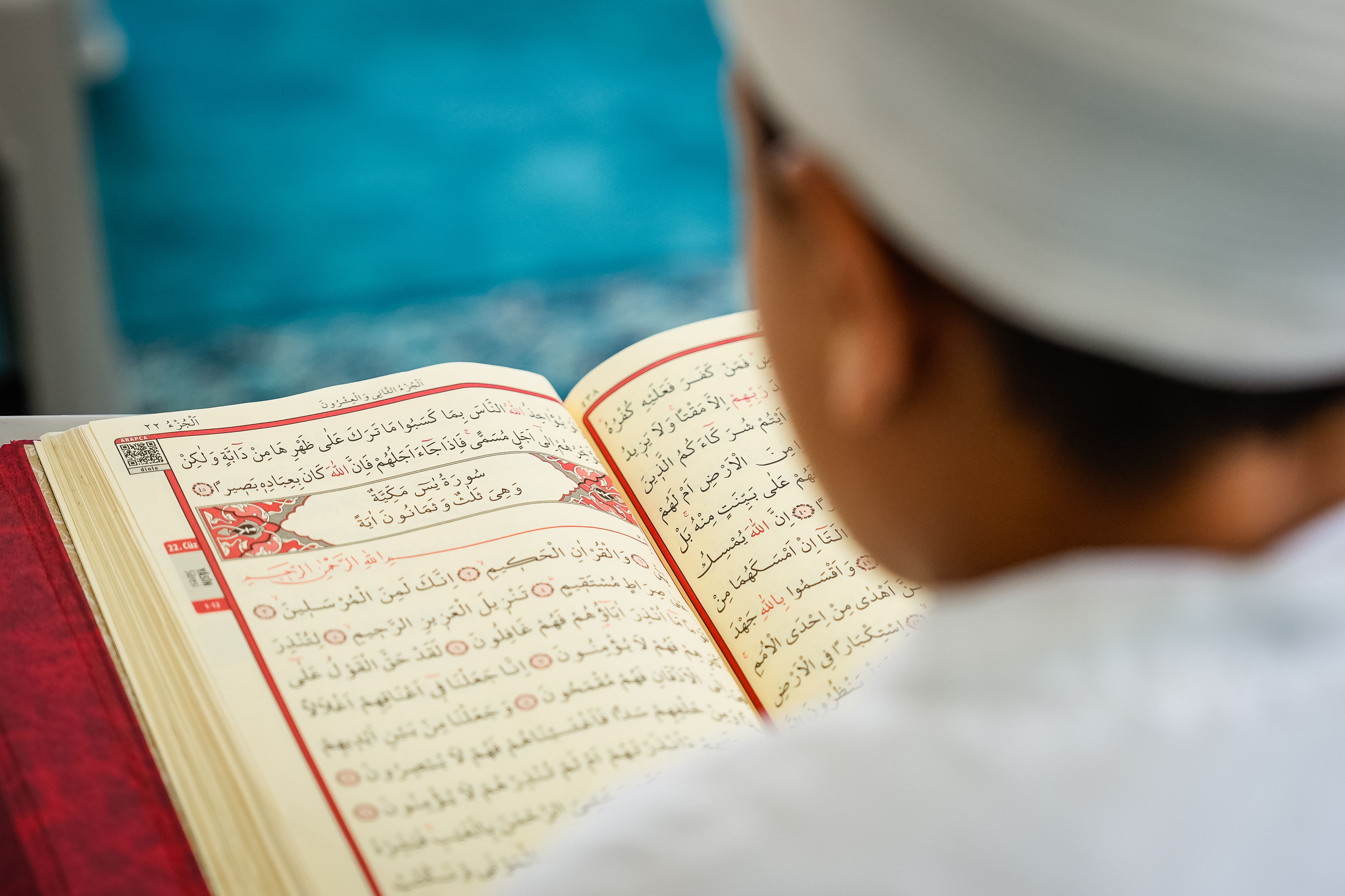 Child reading the Holy Quran with Tajweed