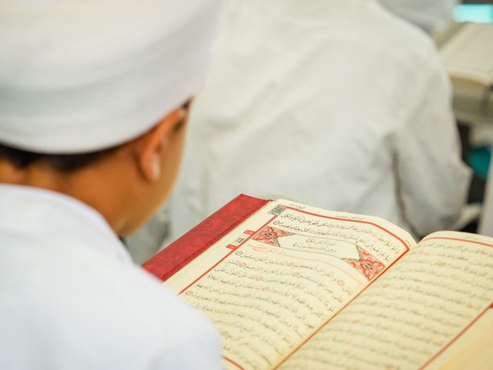 Student reading the Quran during a Quran class