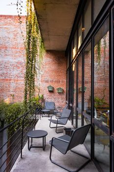 Stylish balcony with modern furniture and brick walls in Mexico City.