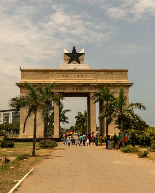 Free The iconic Independence Arch in Accra, Ghana with people walking on a sunny day. Stock Photo