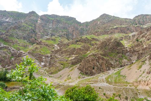 Free Beautiful view of lush green and rocky terrain in the Fann Mountains, Sughd Province, Tajikistan. Stock Photo