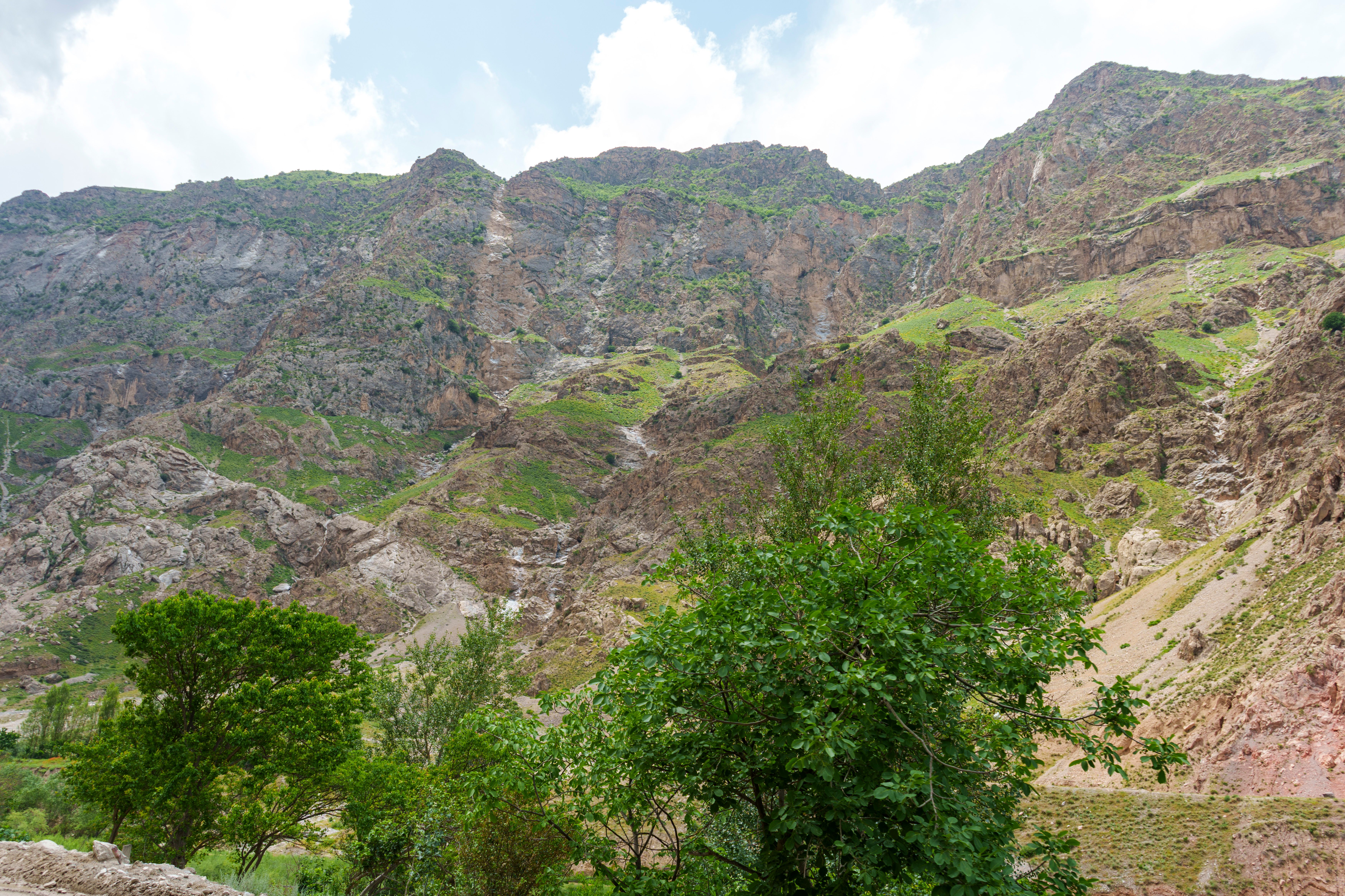 Breathtaking view of rocky mountains and lush greenery in Sughd Province, Tajikistan.