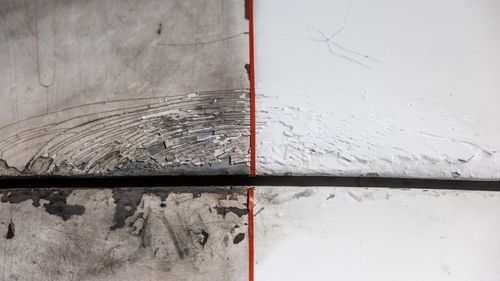 Free Abstract image of a weathered, peeling surface bisected by a thin red line. Stock Photo