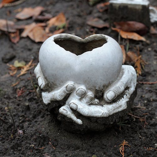 Hands Holding a Heart Clay Sculpture