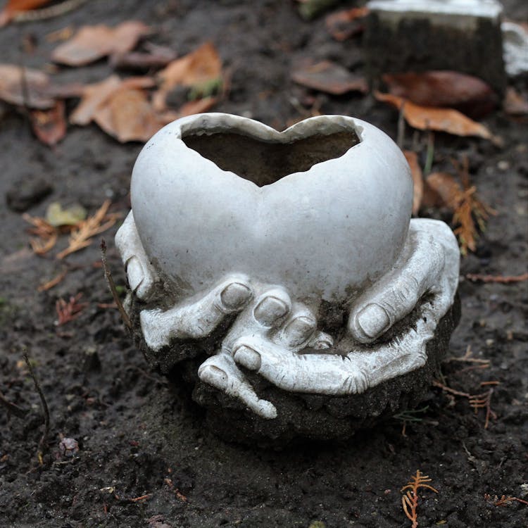 Hands Holding A Heart Clay Sculpture