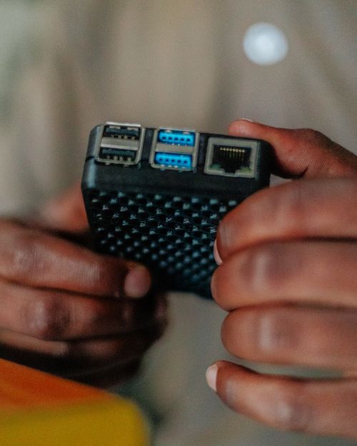 Free Detailed view of hands holding a USB hub with various port connections, ideal for tech and gadget themes. Stock Photo