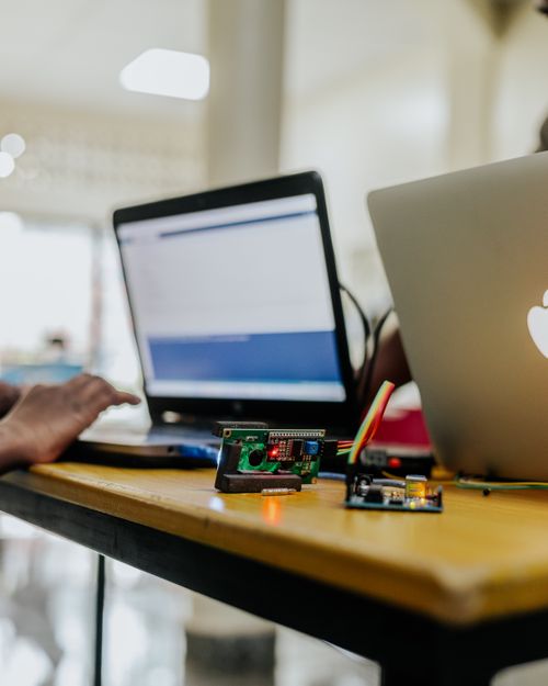 Free High-tech electronics and laptops on a workspace table indoors with blurred background. Stock Photo