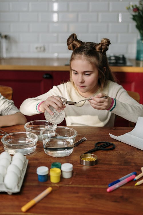 Girl With Cute Hairstyle Holding Spoon and Glass