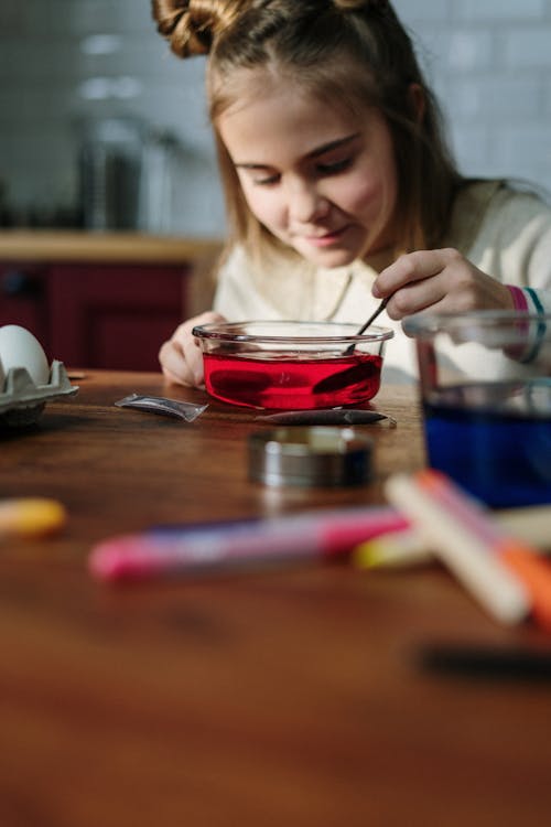 Girl Mixing Red Dye on Bowl of Water