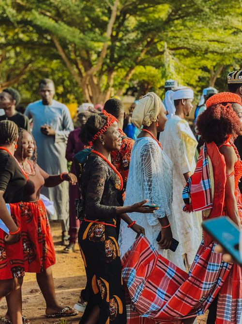 Free Colorful traditional African ceremony showing people in vibrant attire, dancing outdoors. Stock Photo