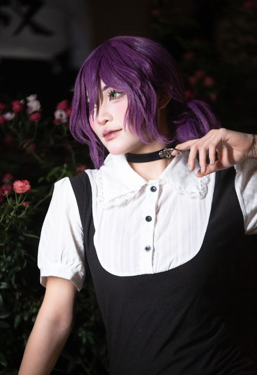 Free Portrait of a cosplayer wearing a purple wig and costume in an artistic setting. Stock Photo
