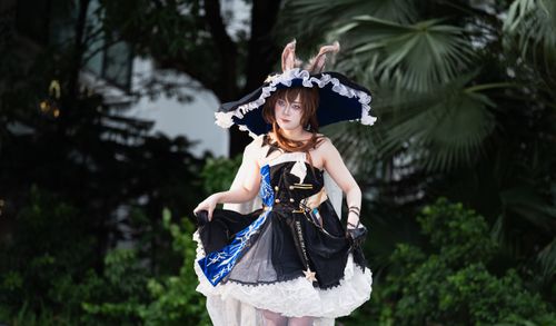 Free Enchanting cosplay character in whimsical fantasy attire set against a lush, outdoor backdrop. Stock Photo