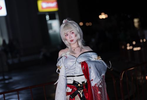 Free A woman in intricate cosplay costume poses at a nighttime event with vivid lighting. Stock Photo