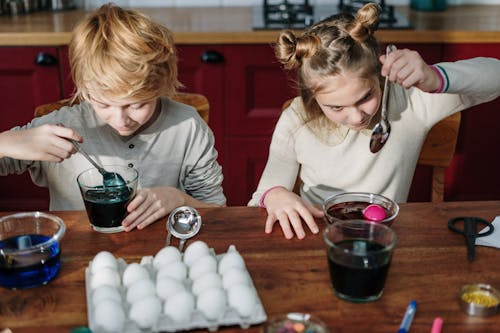 Free Kids Making DIY Easter Eggs Stock Photo