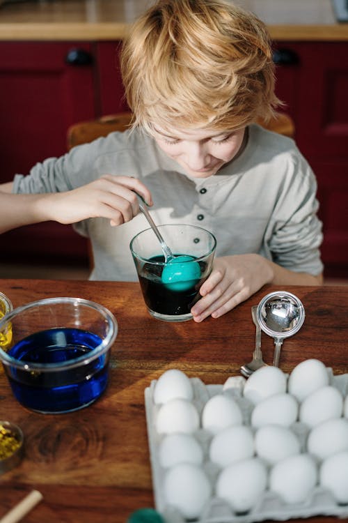 Boy Making Blue Easter Egg