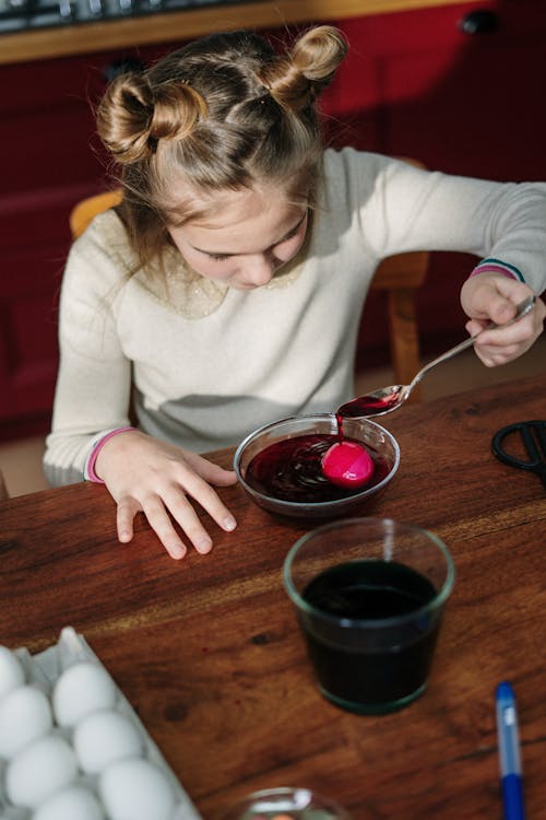 Girl Making Red Easter Egg