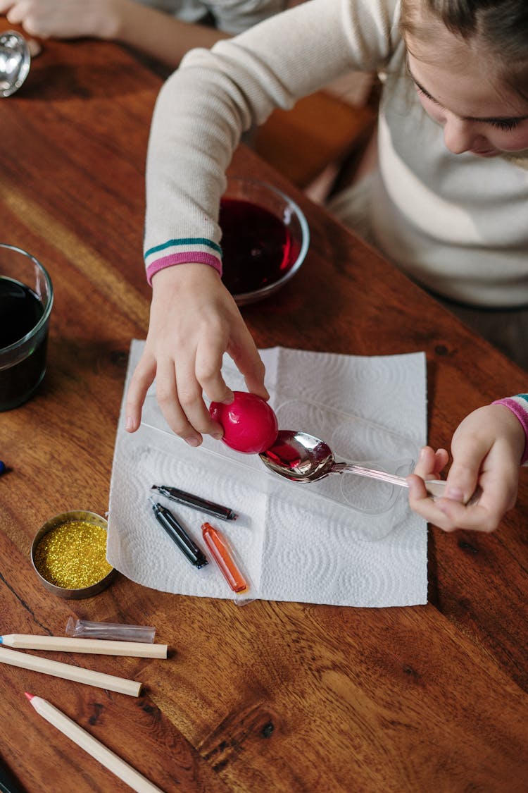 Girl Making Red Easter Egg