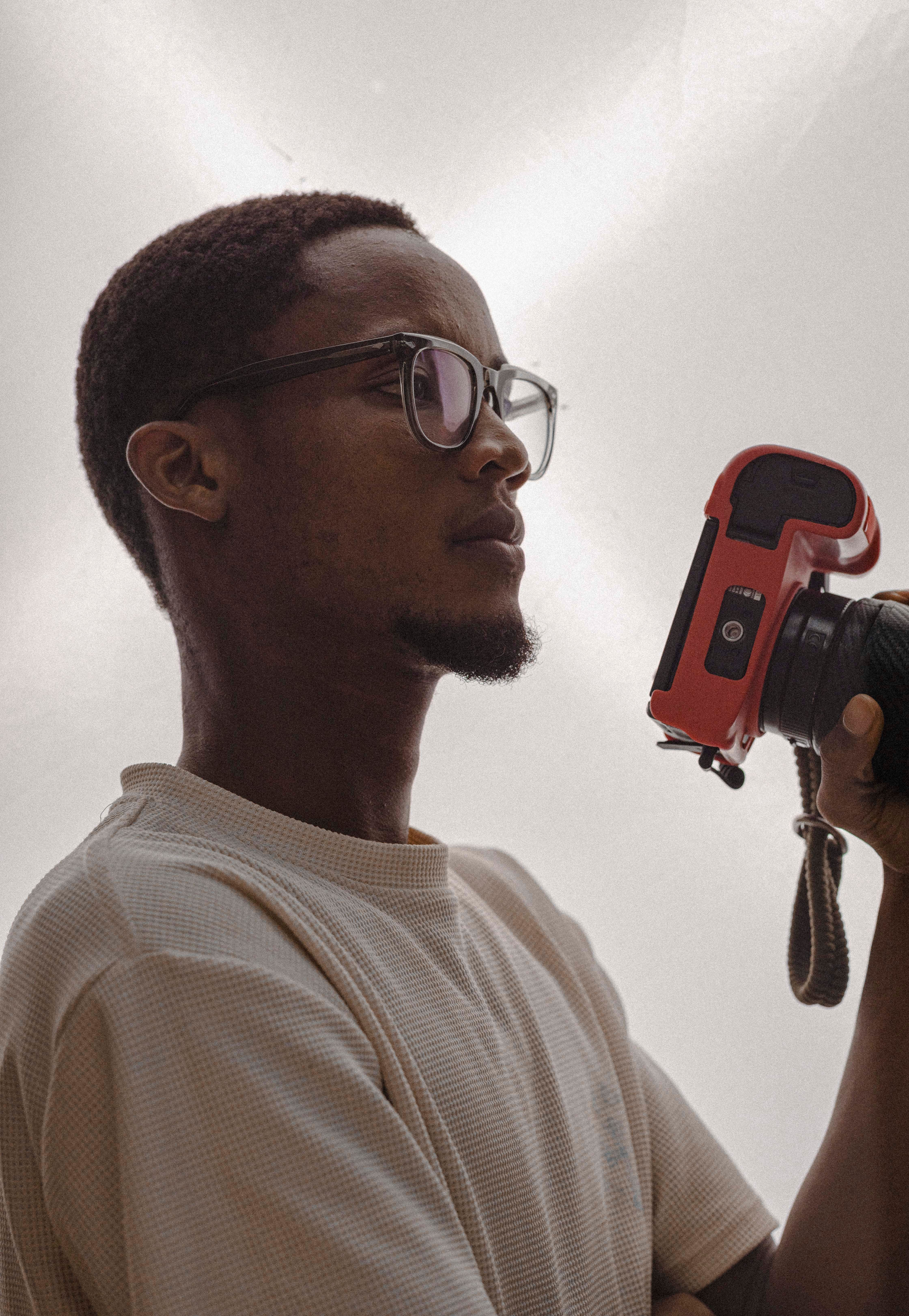 Side profile of a photographer holding a camera, creating a professional vibe.