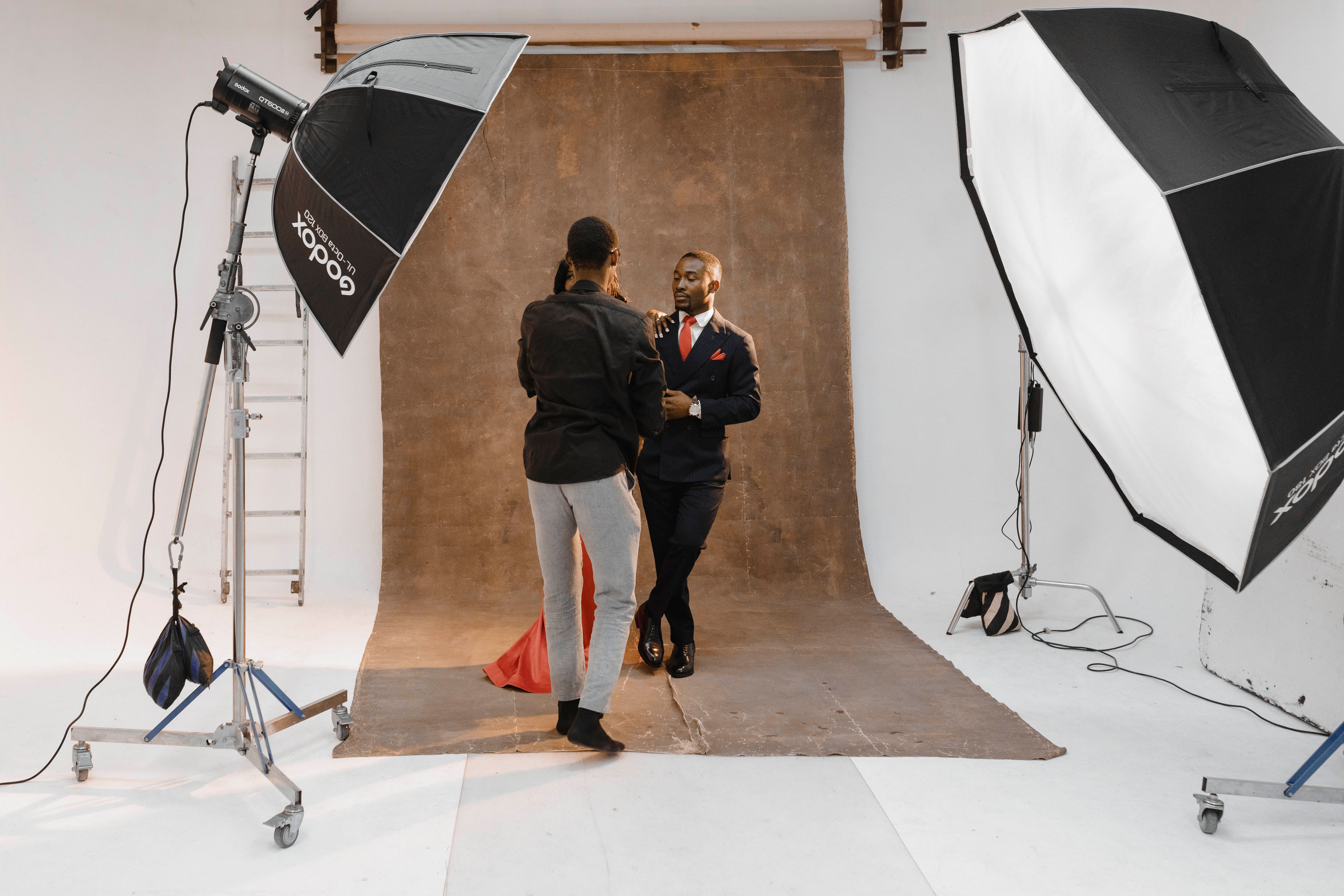 A professional photoshoot session in a Ghanaian studio with lighting equipment and photographer setup.