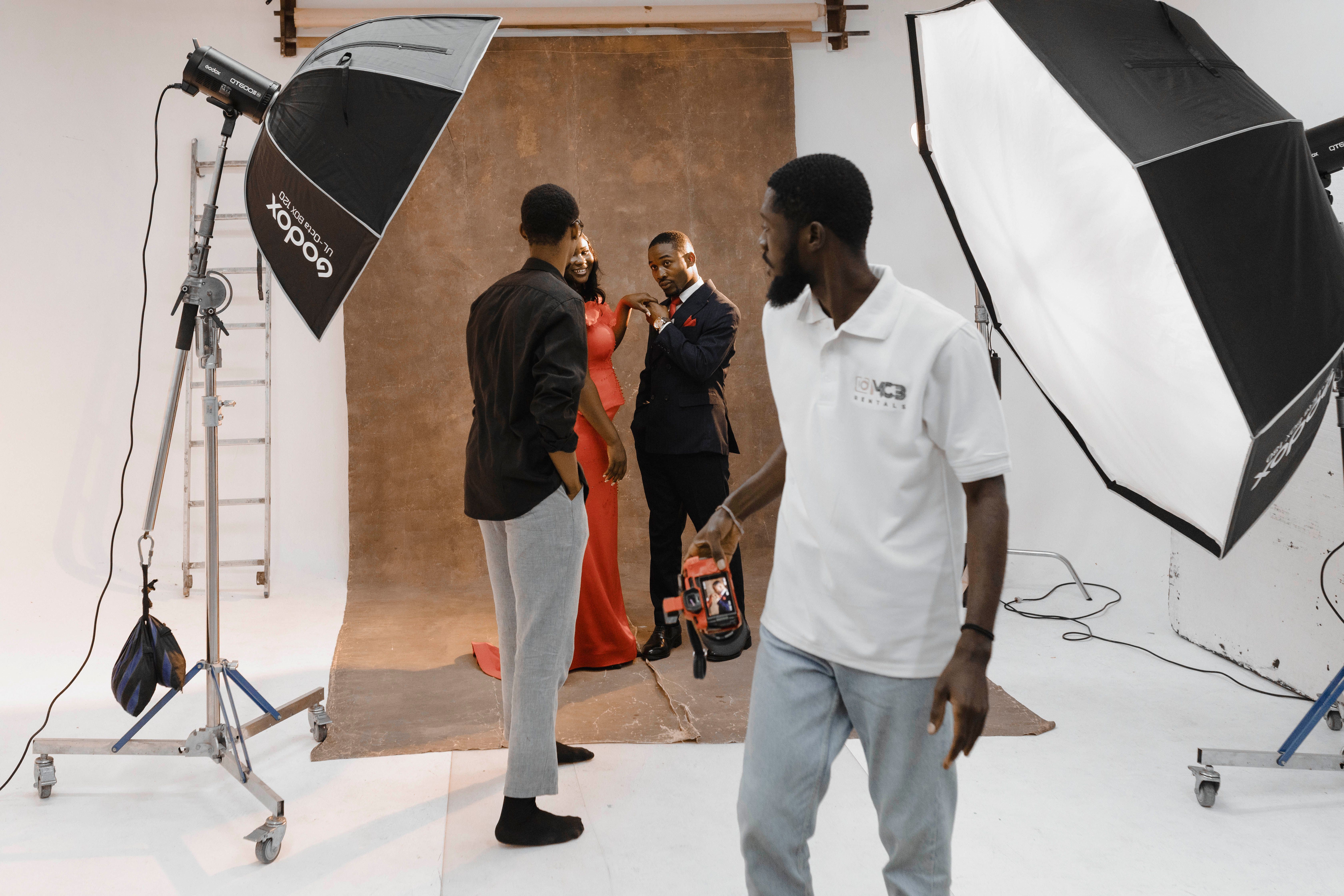 Behind-the-scenes look at a professional studio photoshoot with photographers and models in Accra, Ghana.