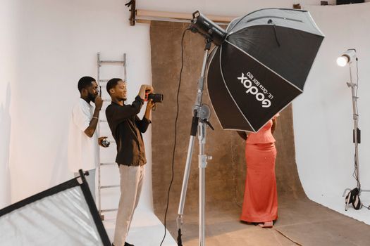 Behind-the-scenes view of a photo shoot session in a modern photography studio. - Fotografer Sidoarjo