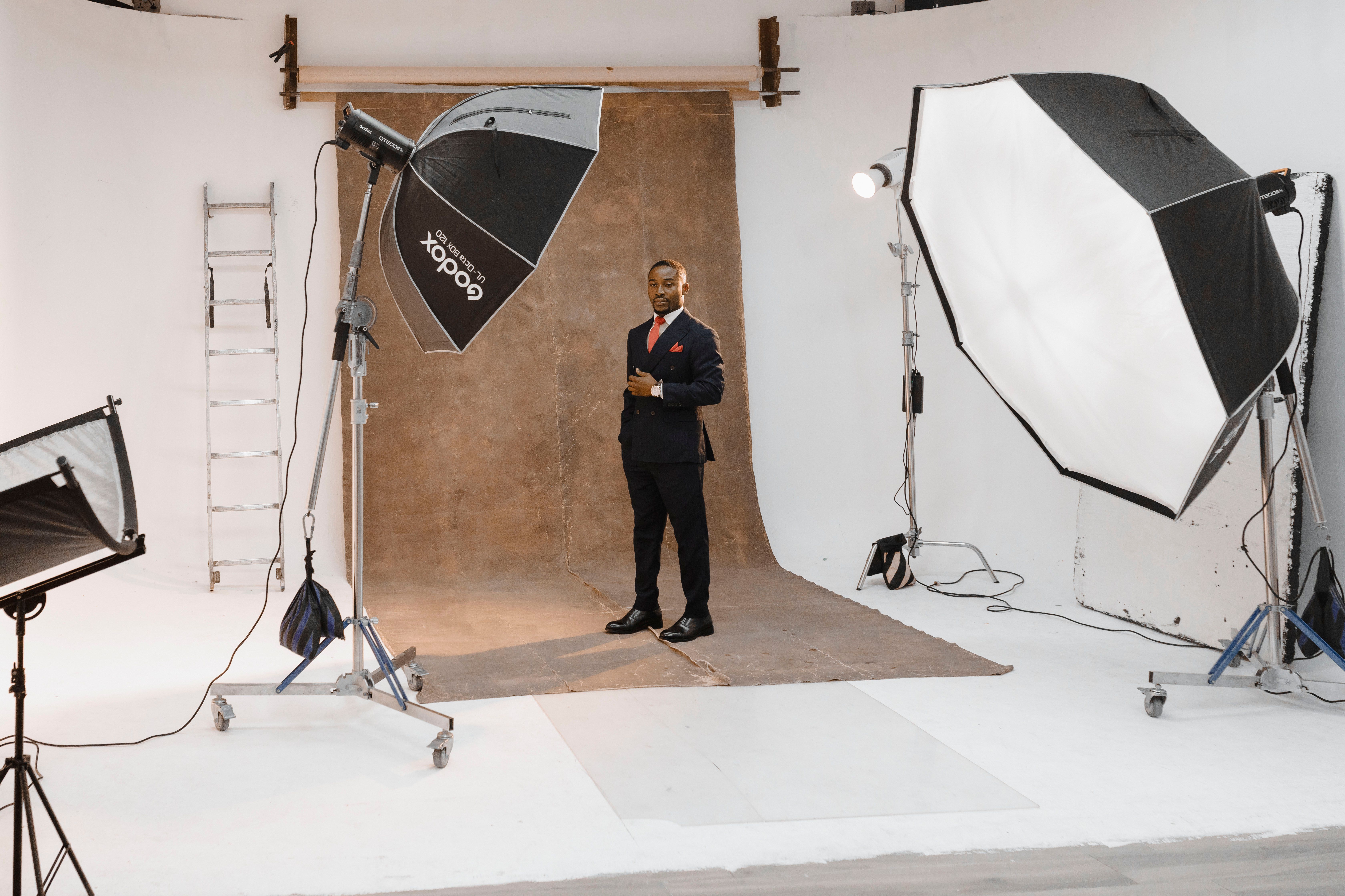 Portrait shoot in a modern photo studio with lighting equipment and professional setup.