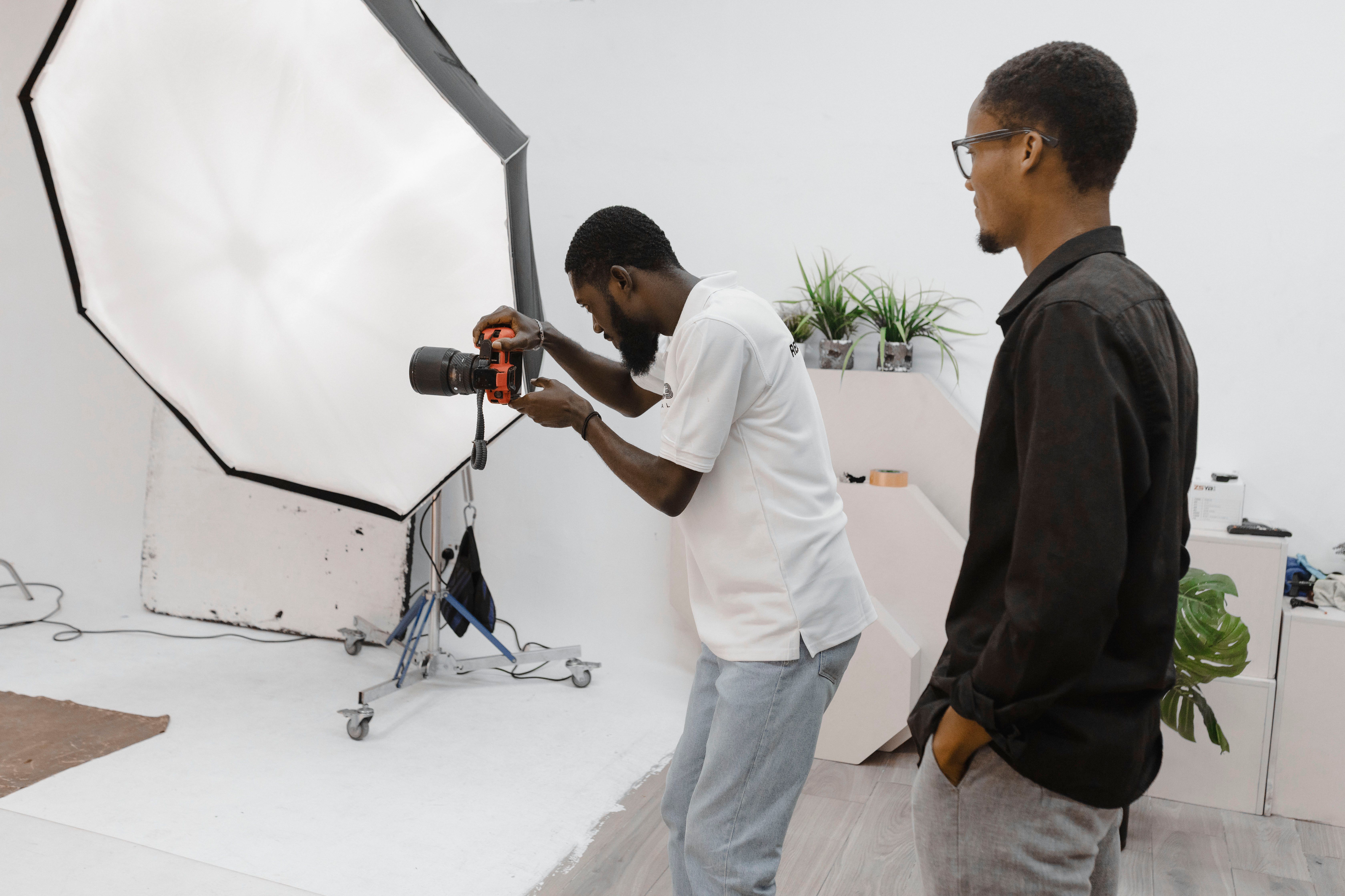 Photographer in action during a studio session in Accra, Ghana, capturing professional portraits.